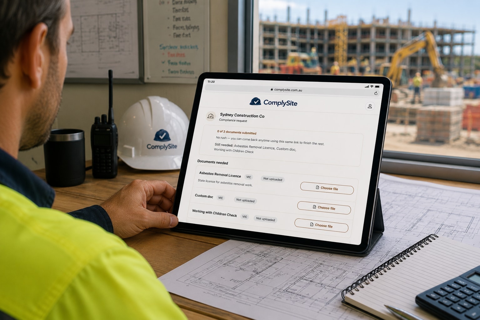 A tradesperson checking their phone on a residential building site